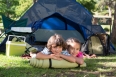 Happy siblings on a camping trip on a sunny day