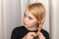 Blond girl braids plait, closeup studio portrait