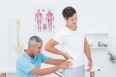 Doctor examining his patient back in medical office