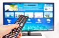 Smart tv and  hand pressing remote control