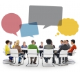 Group of People in Meeting with Speech Bubbles