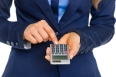 Closeup on business woman using calculator